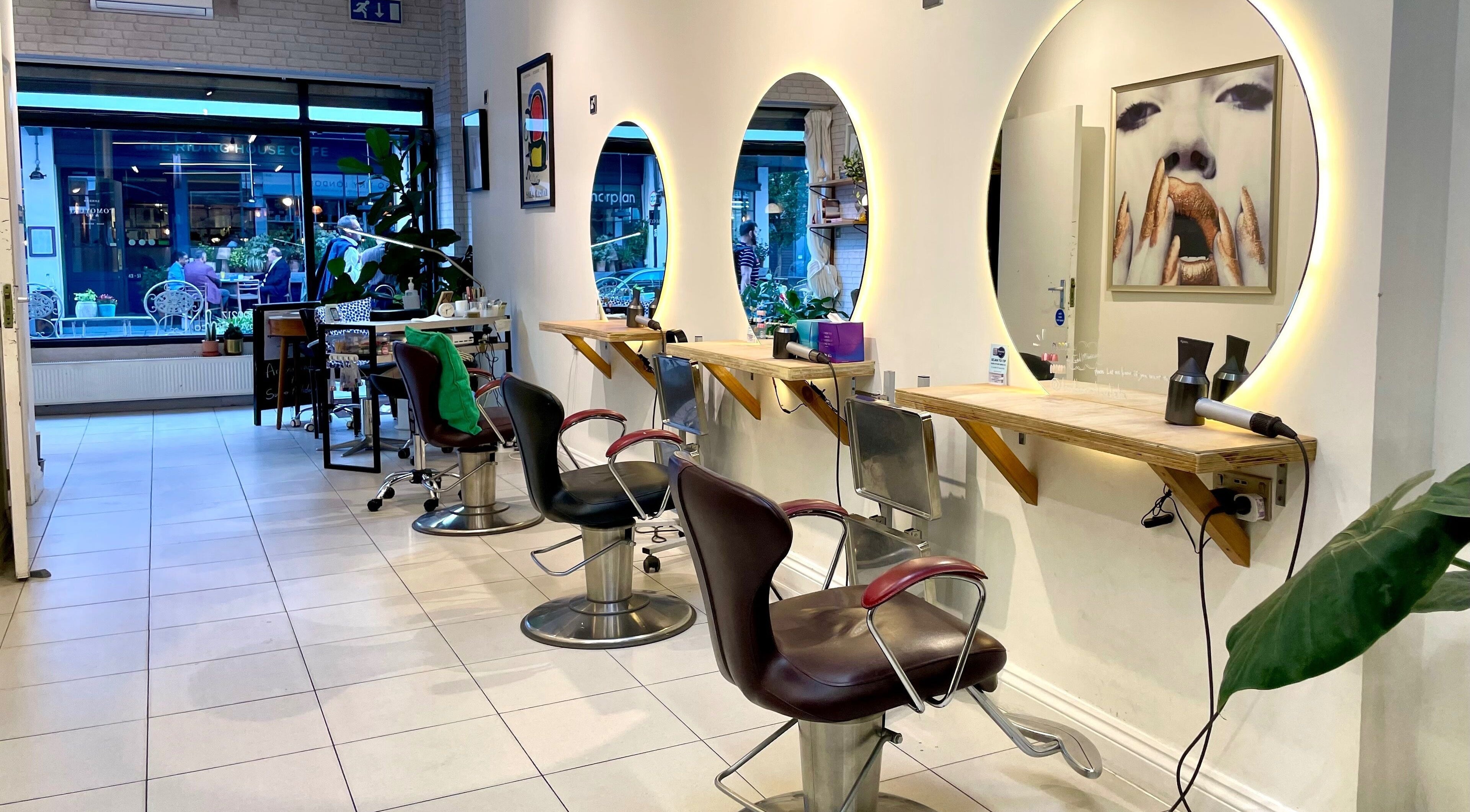 Masahiro salon, London, England, GB, featuring stylish hair stations with illuminated mirrors.