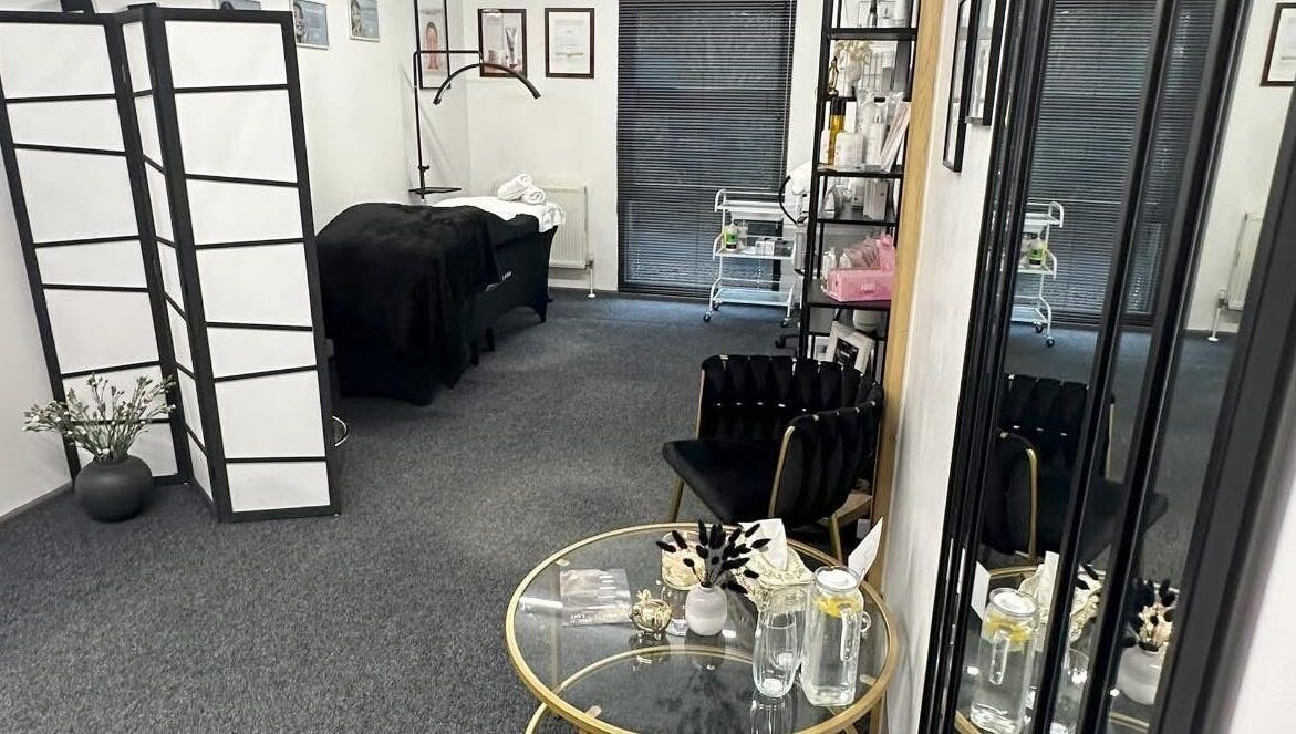 Relaxing interior of Ambers Beauty Studio in Hayle, England, GB with plush chairs and a treatment bed.