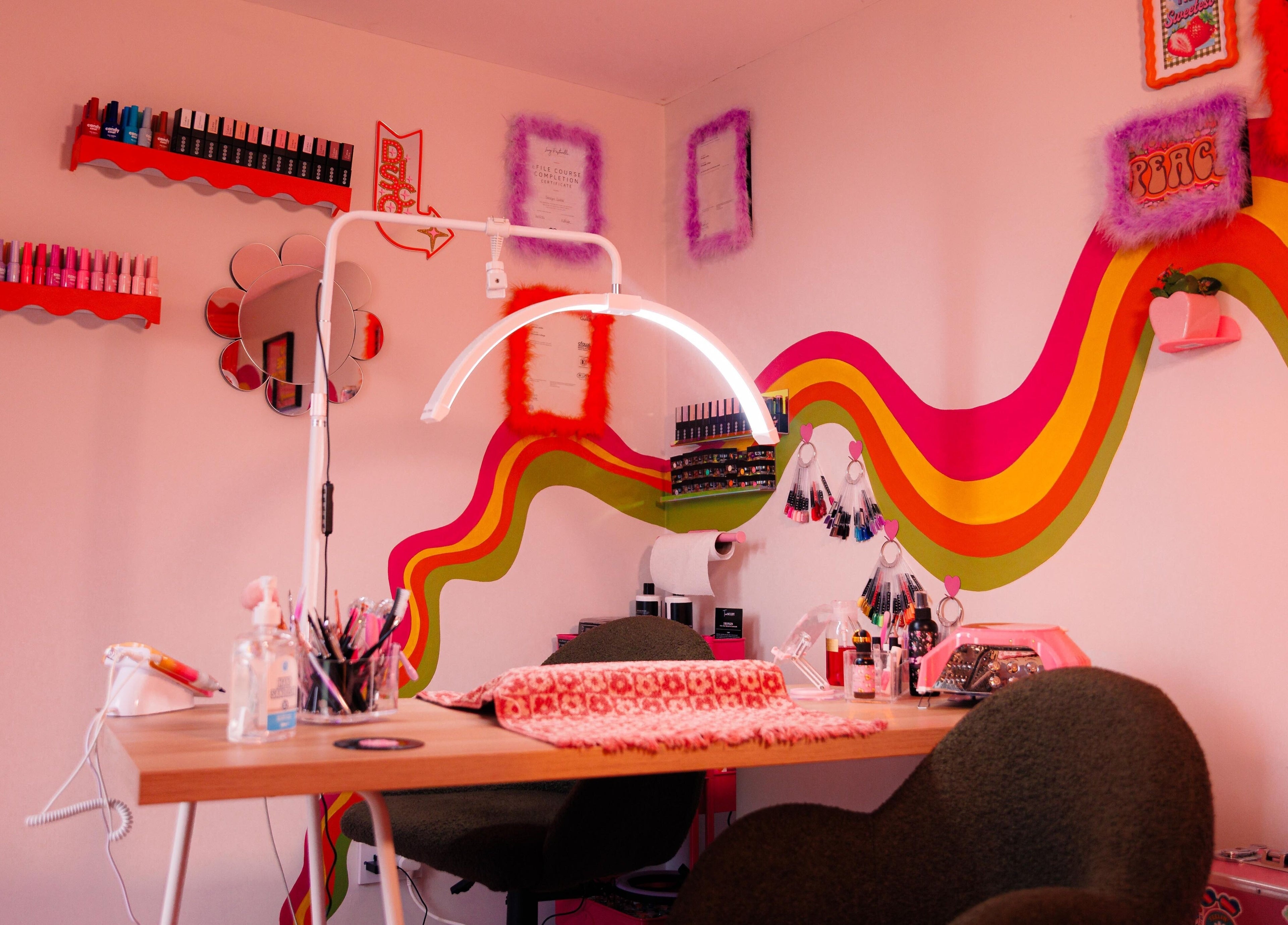 Vibrant nail station at Bobby Dazzler Nails, Winlaton, England, GB with colorful decor and manicure tools.