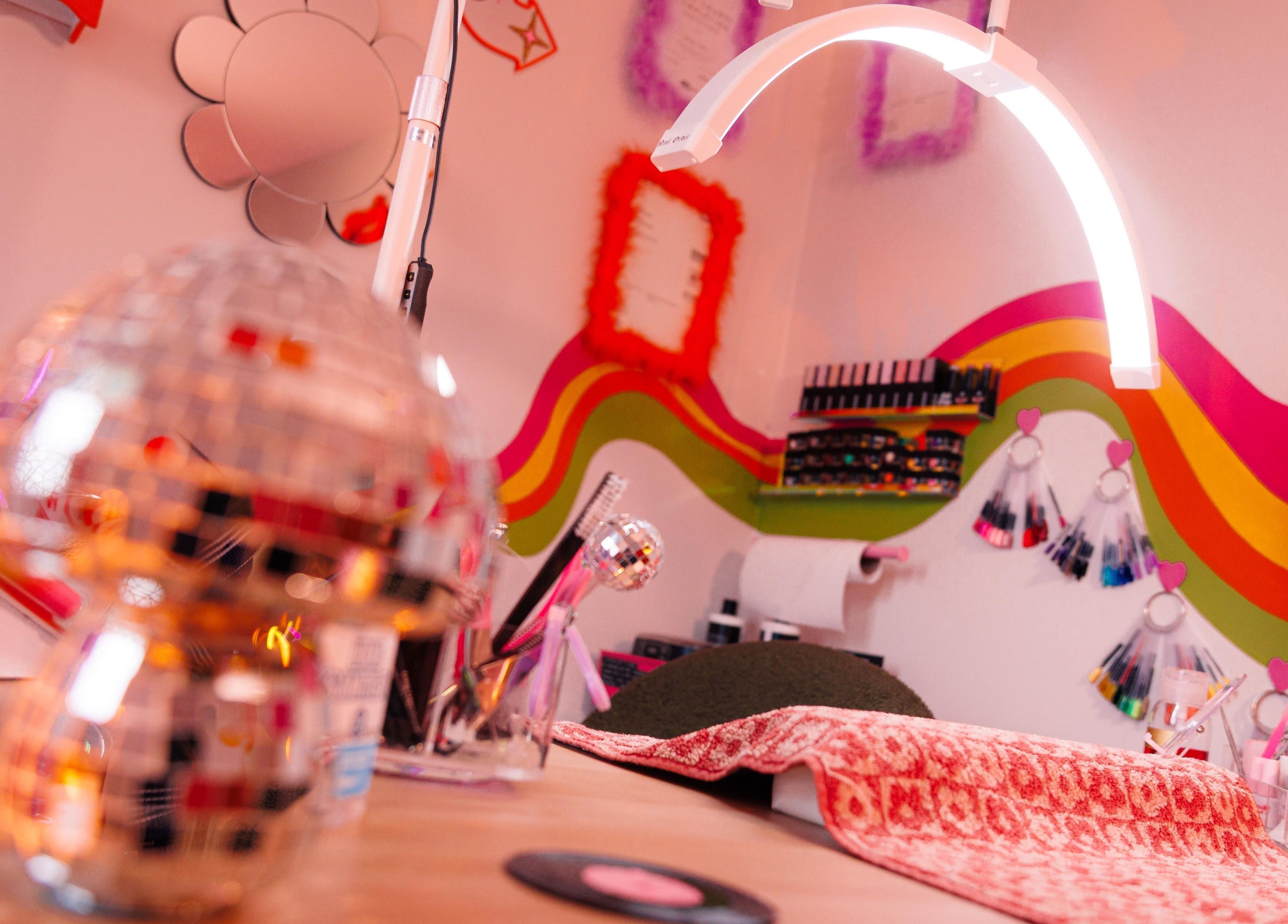 Colorful nail art nook at Bobby Dazzler Nails, Winlaton, England, GB. Bright decor and tools create a lively ambiance.