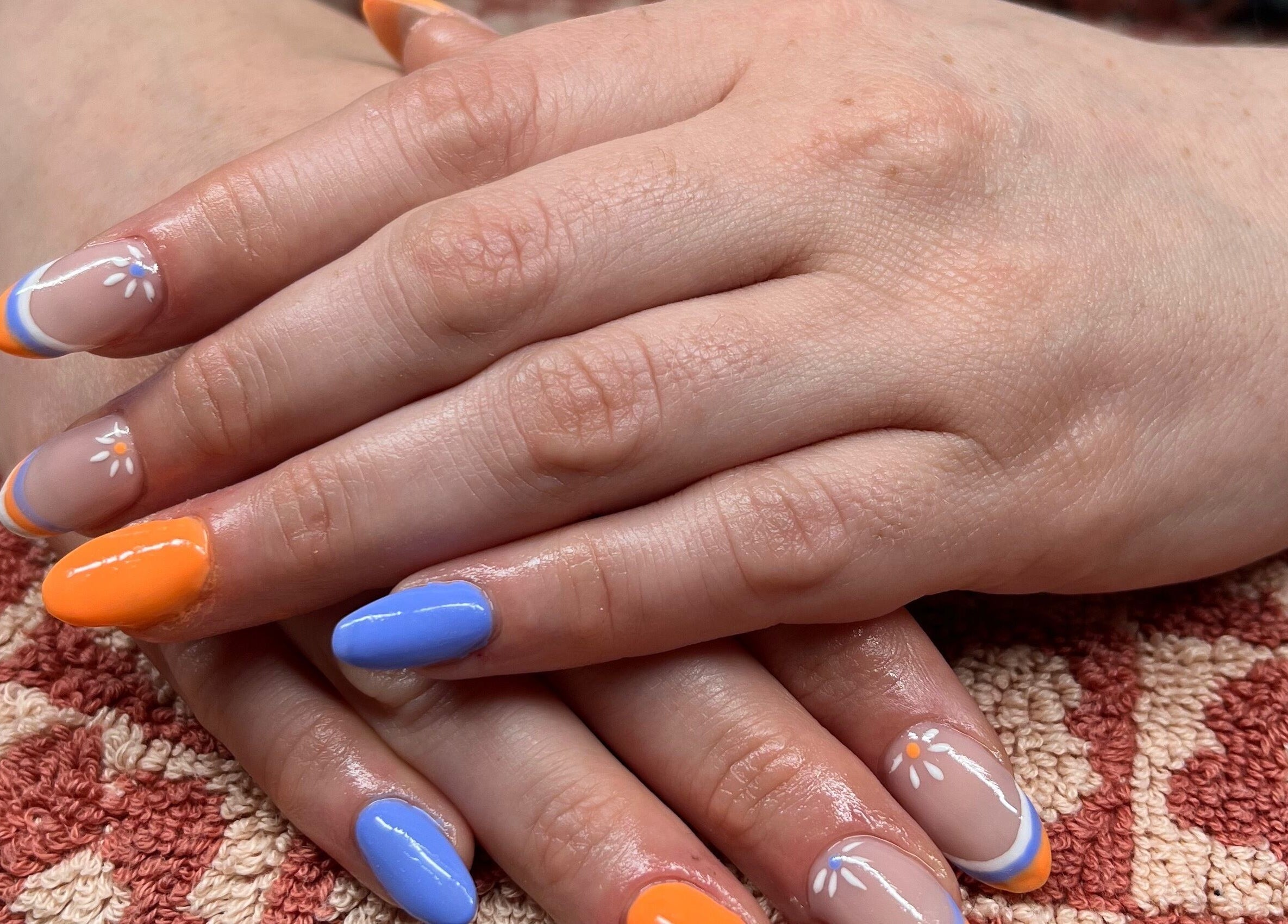 Stylish nails with orange and blue at Bobby Dazzler Nails in Winlaton, England, GB.
