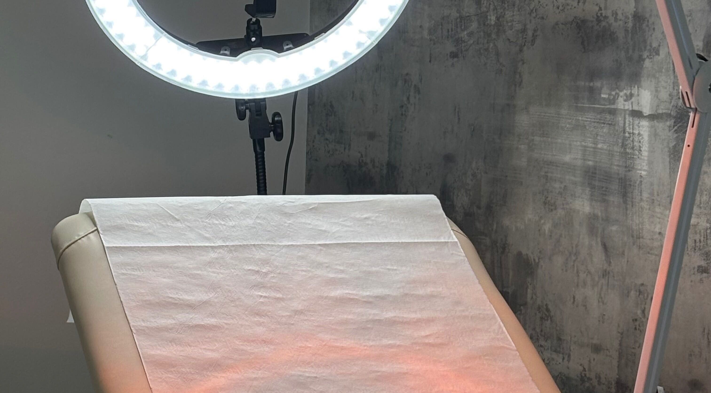 Treatment bed at The Body Lab, Croydon, England, GB with accent lighting creating a serene atmosphere.