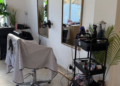 Contemporary barber station at Redz Hedz Barbers in Goldthorpe, England with sleek mirrors and styling tools.