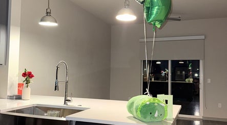 Modern kitchen at D' Flores brows in Dallas, Texas, US with balloons and red roses on the counter.