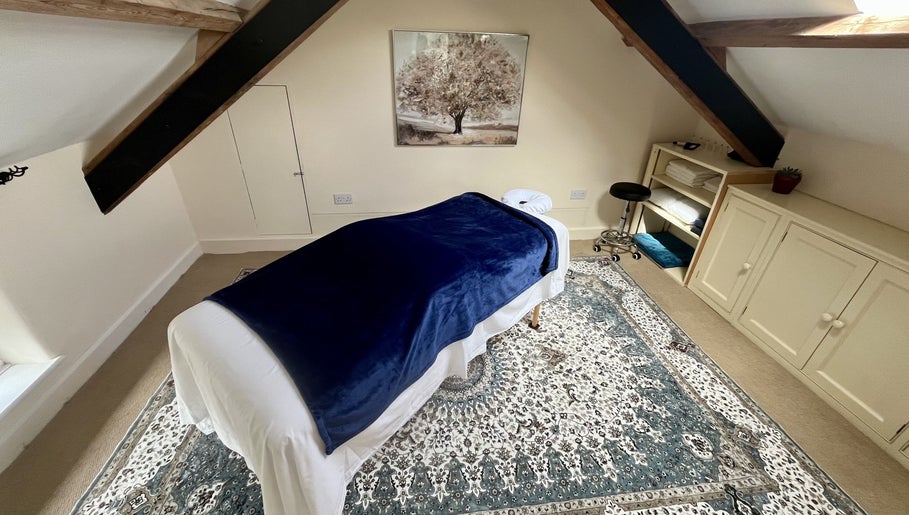 Peaceful massage room with blue cover at Sacred Tree Wellness, Tiverton, England, GB.