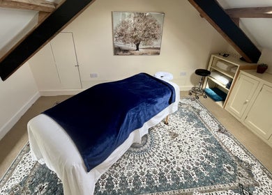 Peaceful massage room with blue cover at Sacred Tree Wellness, Tiverton, England, GB.