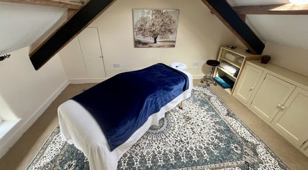 Peaceful massage room with blue cover at Sacred Tree Wellness, Tiverton, England, GB.