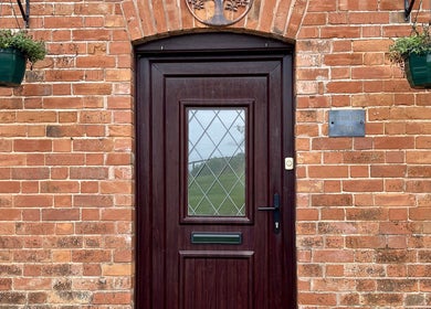 Front door with brick archway at Sacred Tree Wellness, Tiverton, England, GB.