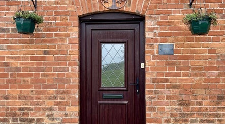 Front door with brick archway at Sacred Tree Wellness, Tiverton, England, GB.