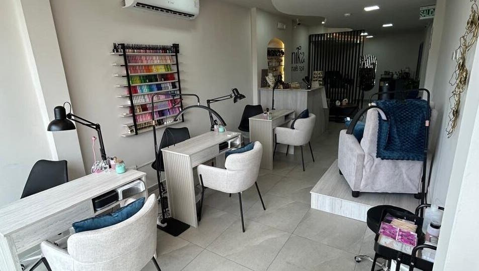 Interior moderno de Nika Nails Spa en Guayaquil, Guayas, EC, mostrando estaciones de manicura elegantes.