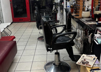 Interior of TEDDYBARBERS in London, England, GB with modern chairs and sleek decor.