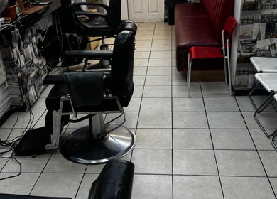 Interior of TEDDYBARBERS in London, England, GB featuring barber chairs and modern decor.