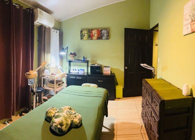 Relaxing massage room at Sunset Body Works, Uvita, Provincia De Puntarenas, CR with green decor and serene ambiance.