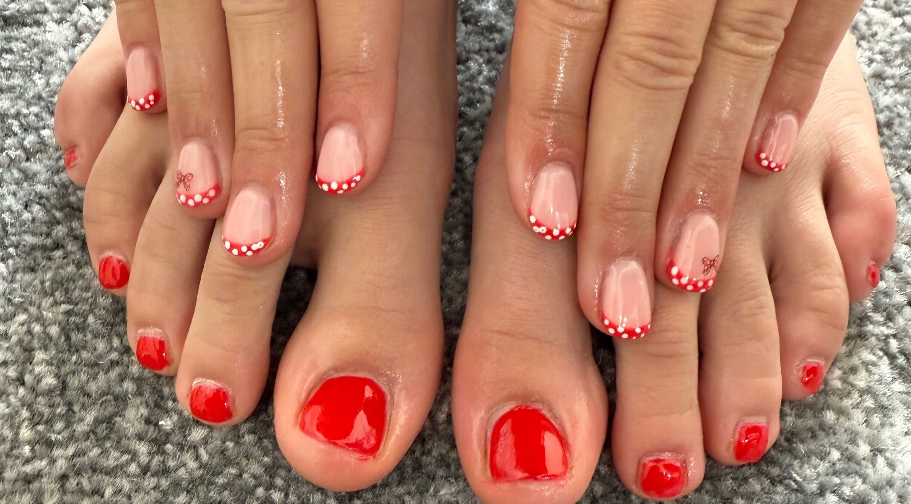 Elegant red nails with polka dots by Jewels Not Tools by Amy in Newton Mearns, Scotland, GB.