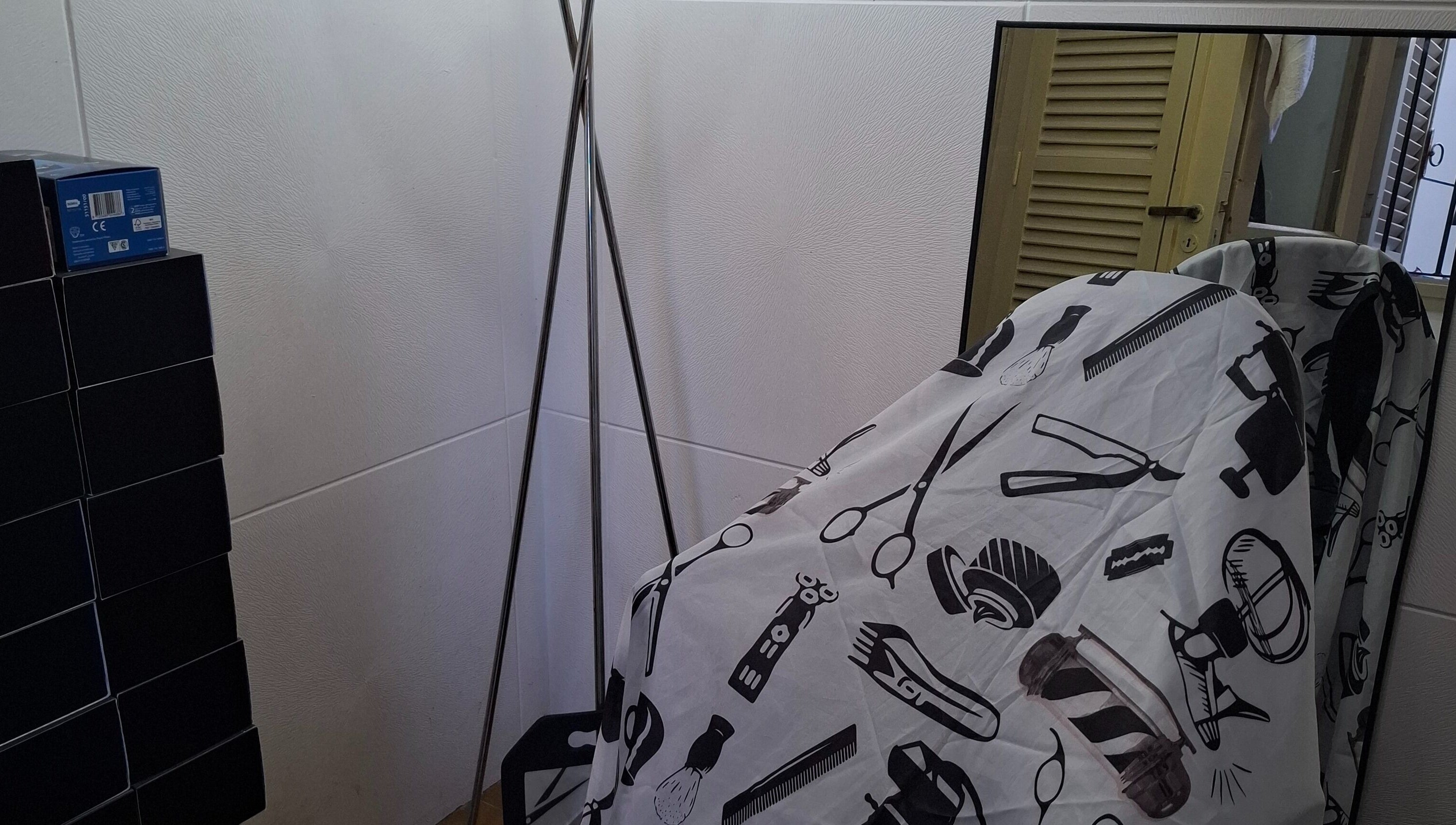 Rincón de barbería en JCStudio con espejo y funda estampada en Rosario, Santa Fe, AR.