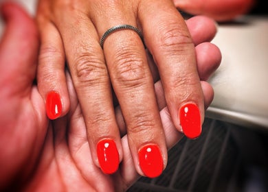 Bright red manicure at Freedombeauty, Plymouth, England, GB, showcasing elegant nail care service.