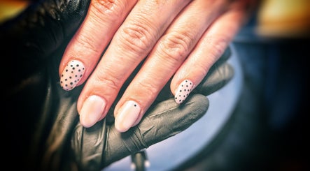 Polka dot nail art at Freedombeauty, Plymouth, England, GB. Elegant manicure with black dots on nude nails.