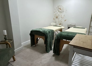 Serene massage room at LivSkin, Gqeberha, Eastern Cape, ZA, featuring twin beds with green throws.