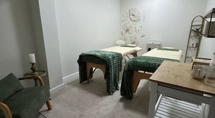 Serene massage room at LivSkin, Gqeberha, Eastern Cape, ZA, featuring twin beds with green throws.