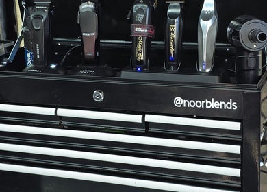 A neatly organized grooming toolbox at Noor Blends, London, England, GB showcasing professional hair tools.