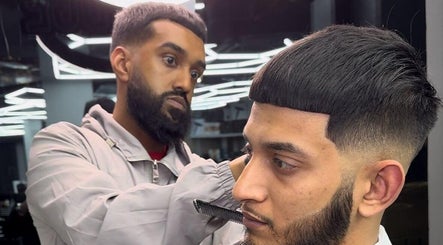 Stylist perfecting a haircut at Noor Blends, London, England, GB, showcasing expert barber skills.