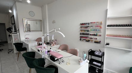 Elegant nail salon at Andreea Arcalianu, Dagenham, England, GB, showcasing polishes and modern design.
