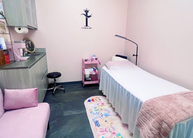 Tranquil treatment room at I Lash & Art, Monrovia, California, US with soft lighting and comfortable bedding.