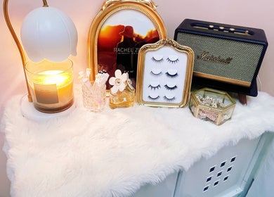 Elegant decor with candle, frames, and lashes at I Lash & Art in Monrovia, California, US.