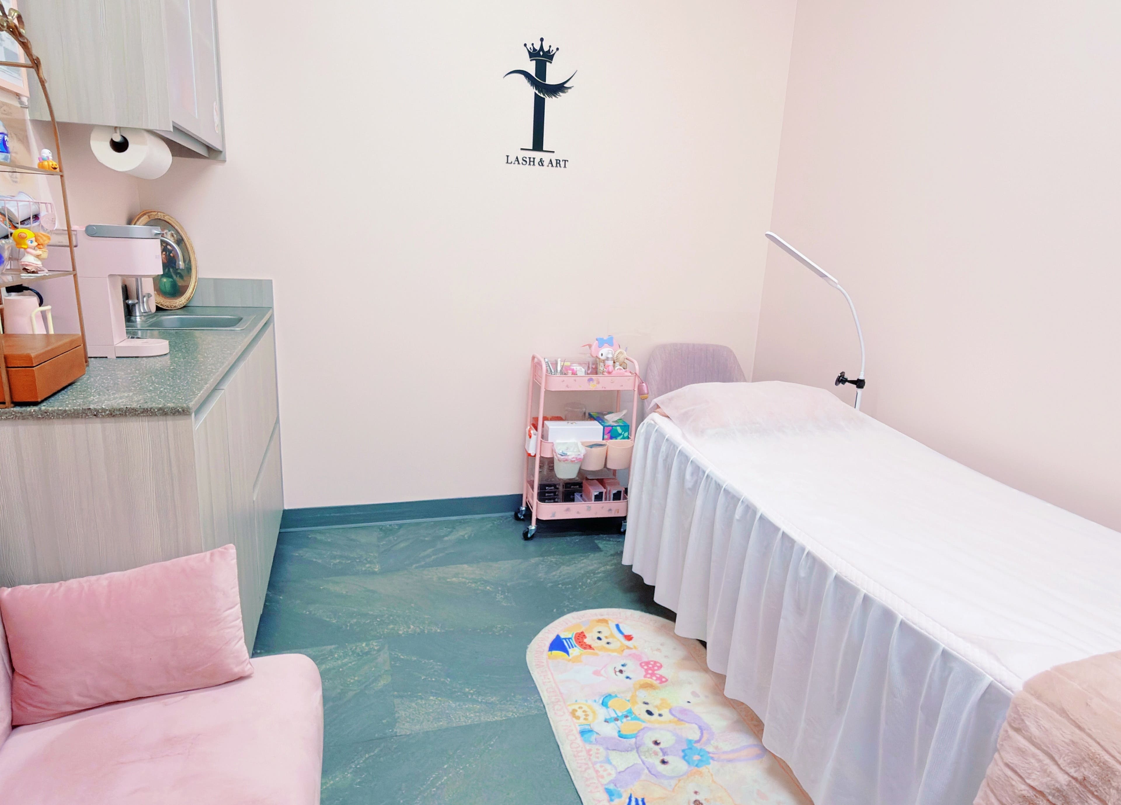 Cozy treatment room at I Lash & Art, Monrovia, California, US, featuring a plush pink seating area.