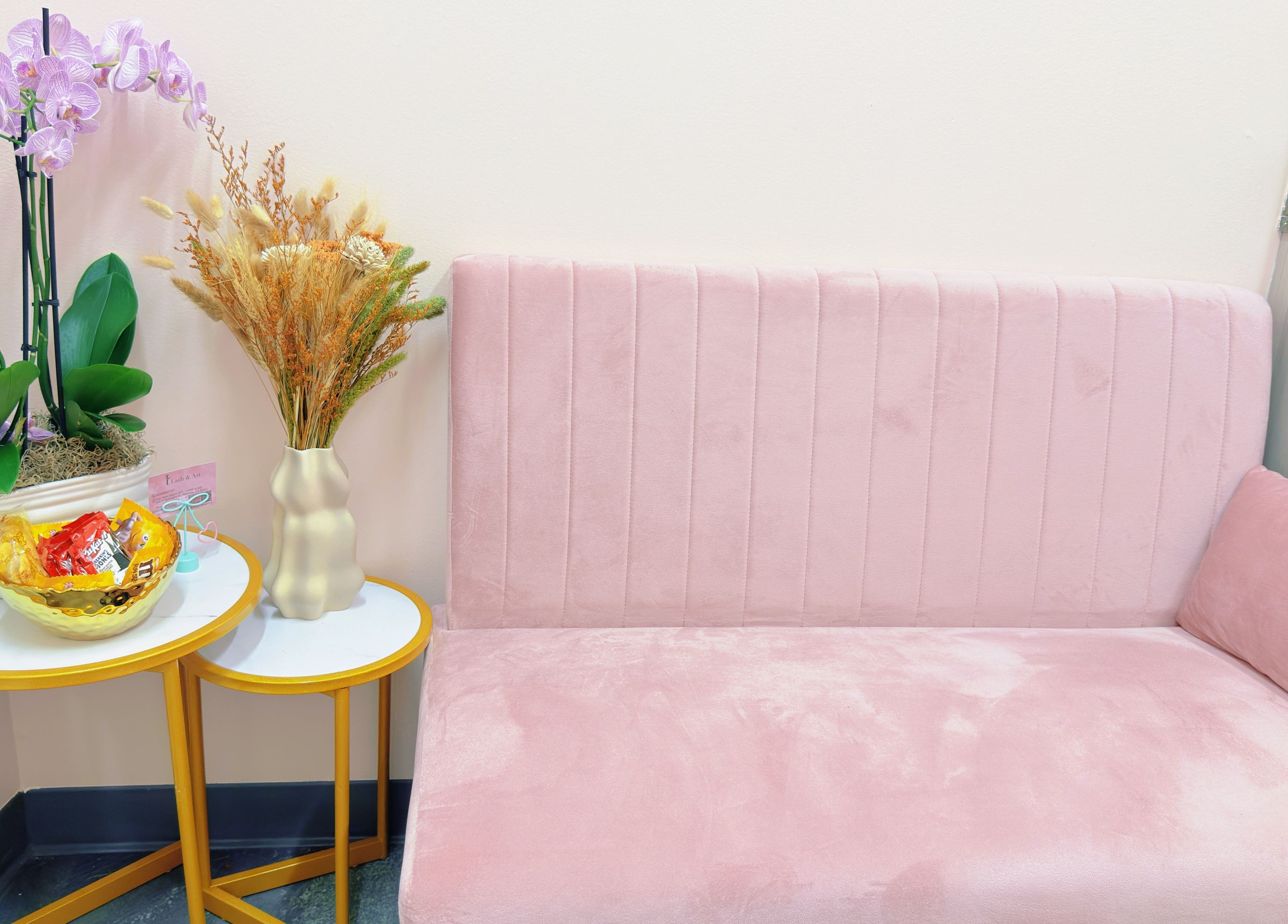 Elegant pink seating area at I Lash & Art, Monrovia, California, US, featuring modern decor and florals.