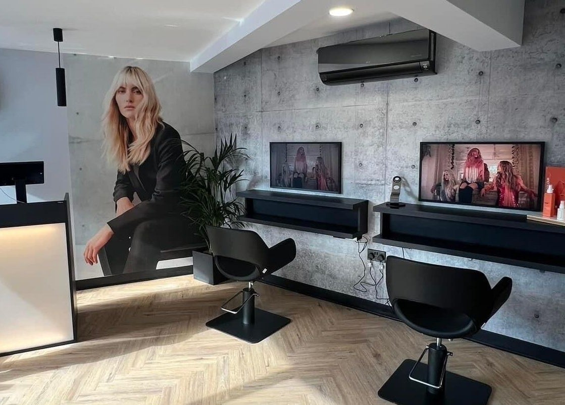 Modern salon interior at Bangs Salon Tutbury, Tutbury, England, GB, featuring sleek chairs and stylish decor.