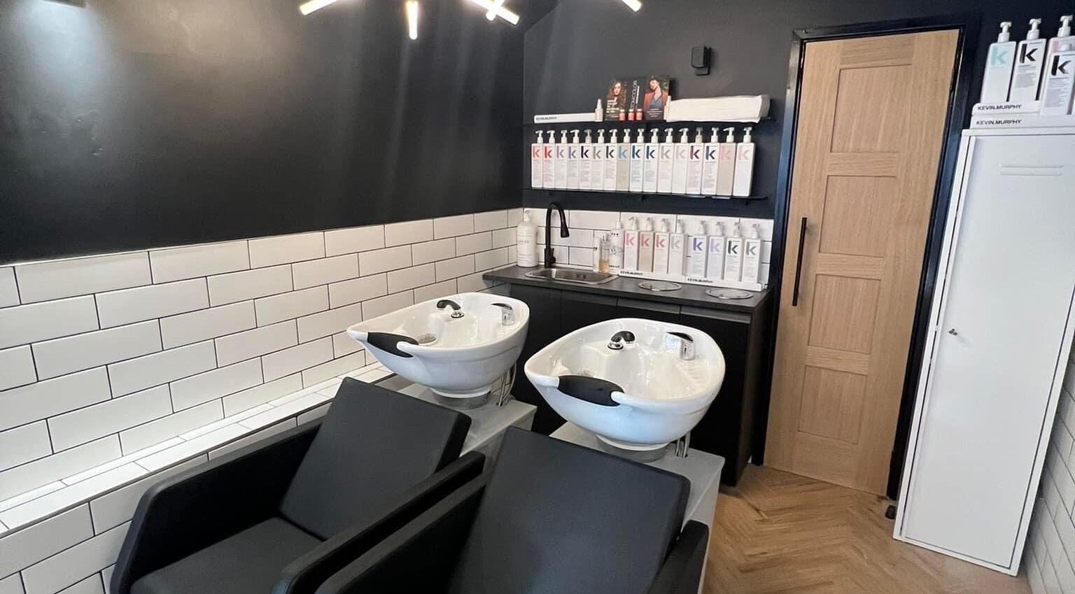 Modern wash stations at Bangs Salon Tutbury, Tutbury, England, GB, featuring sleek sinks and a chic interior.