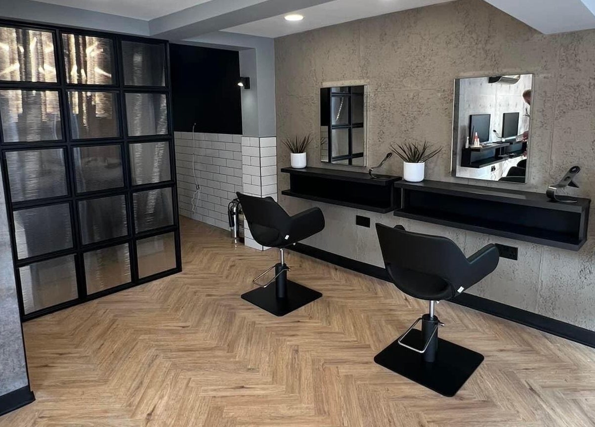 Modern salon with sleek chairs at Bangs Salon Tutbury, Tutbury, England, GB, showcasing elegant design.