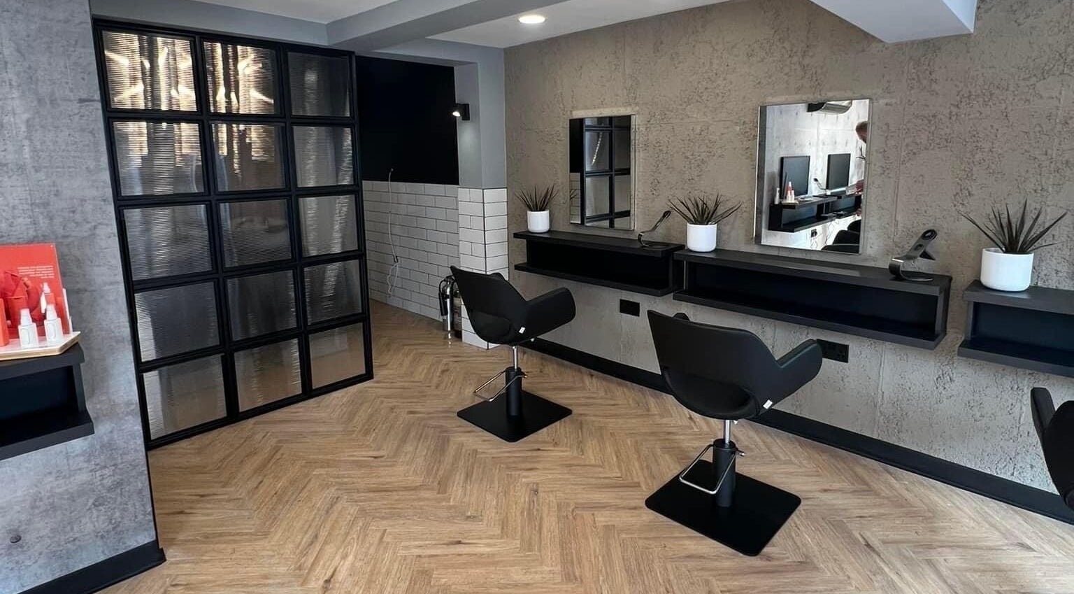 Modern salon with sleek chairs at Bangs Salon Tutbury, Tutbury, England, GB, showcasing elegant design.