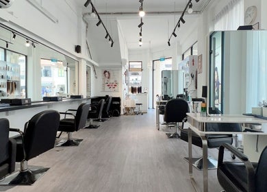Modern, spacious interior of JT Hair and Beauty Salon in Singapore, SG with sleek, stylish décor and seating.