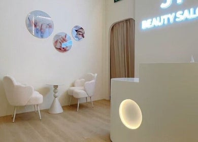 Chic reception area at JT Hair and Beauty Salon, Singapore, Singapore, SG with modern decor and cozy seating.