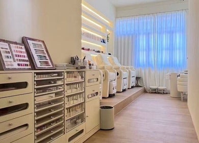 Luxurious interior of JT Hair and Beauty Salon in Singapore, SG featuring elegant chairs and nail color displays.