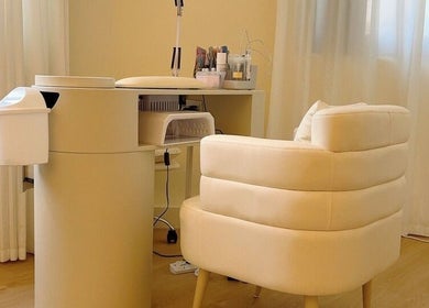 Elegant nail station at JT Hair and Beauty Salon, Singapore, SG with a plush chair and soft lighting.