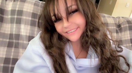 Smiling person indoors at Nails by Paige in Payson, Arizona, US, showcasing cozy ambiance.