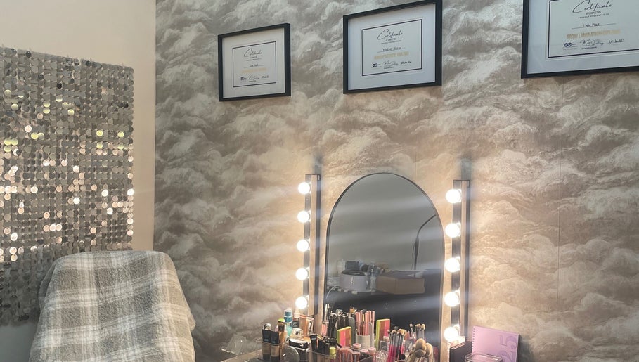 Makeup station at nadinenixonbeauty in Portadown, Northern Ireland, GB featuring illuminated mirror and certificates.