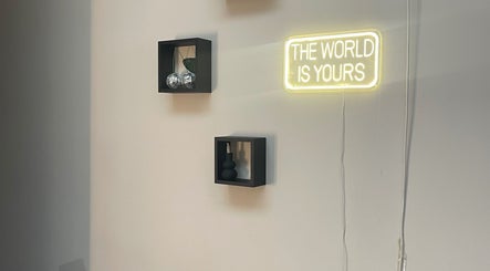 Modern wall decor with neon sign 'The World is Yours' at nadinenixonbeauty, Portadown, Northern Ireland, GB.