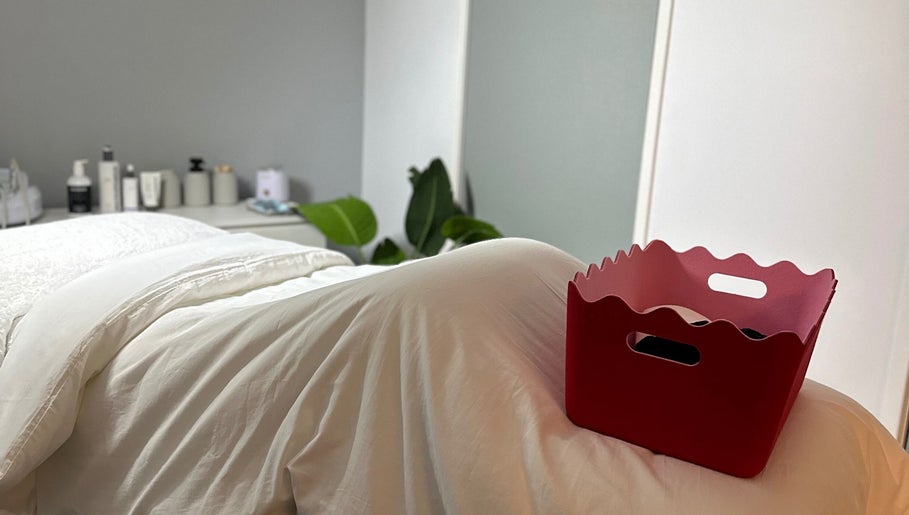 Cozy treatment room at byKT, Redland Bay, Queensland, AU, featuring plush bedding and ambient decor.