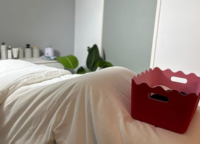 Cozy treatment room at byKT, Redland Bay, Queensland, AU, featuring plush bedding and ambient decor.
