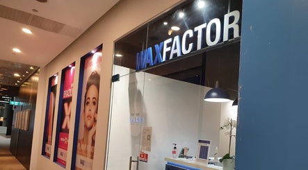 Entrance of Wax Factor Orchard Central, beauty salon in Singapore, Singapore, SG with vibrant posters.