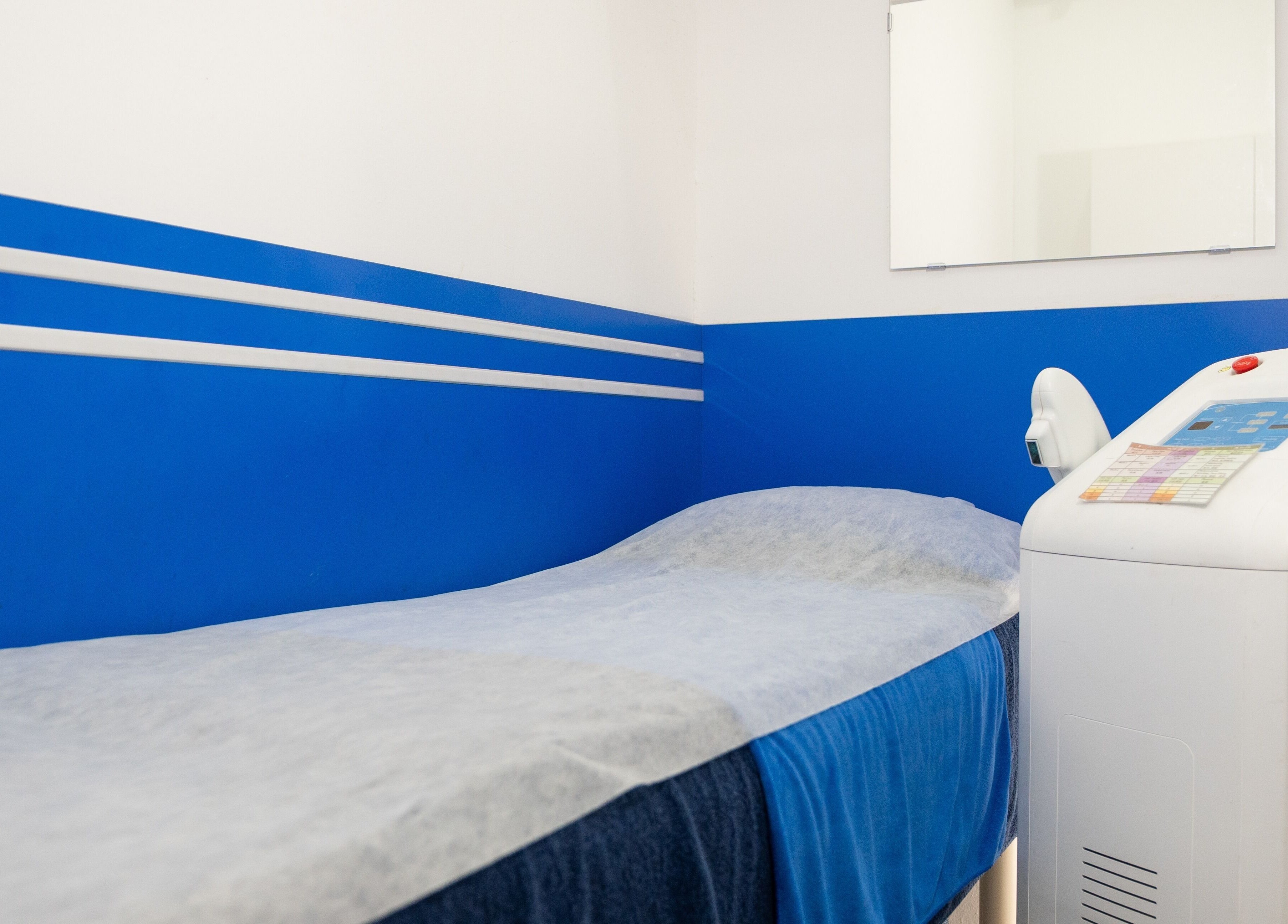 Modern treatment room at Wax Factor Tanjong Pagar, Singapore, SG with blue accents and advanced equipment.