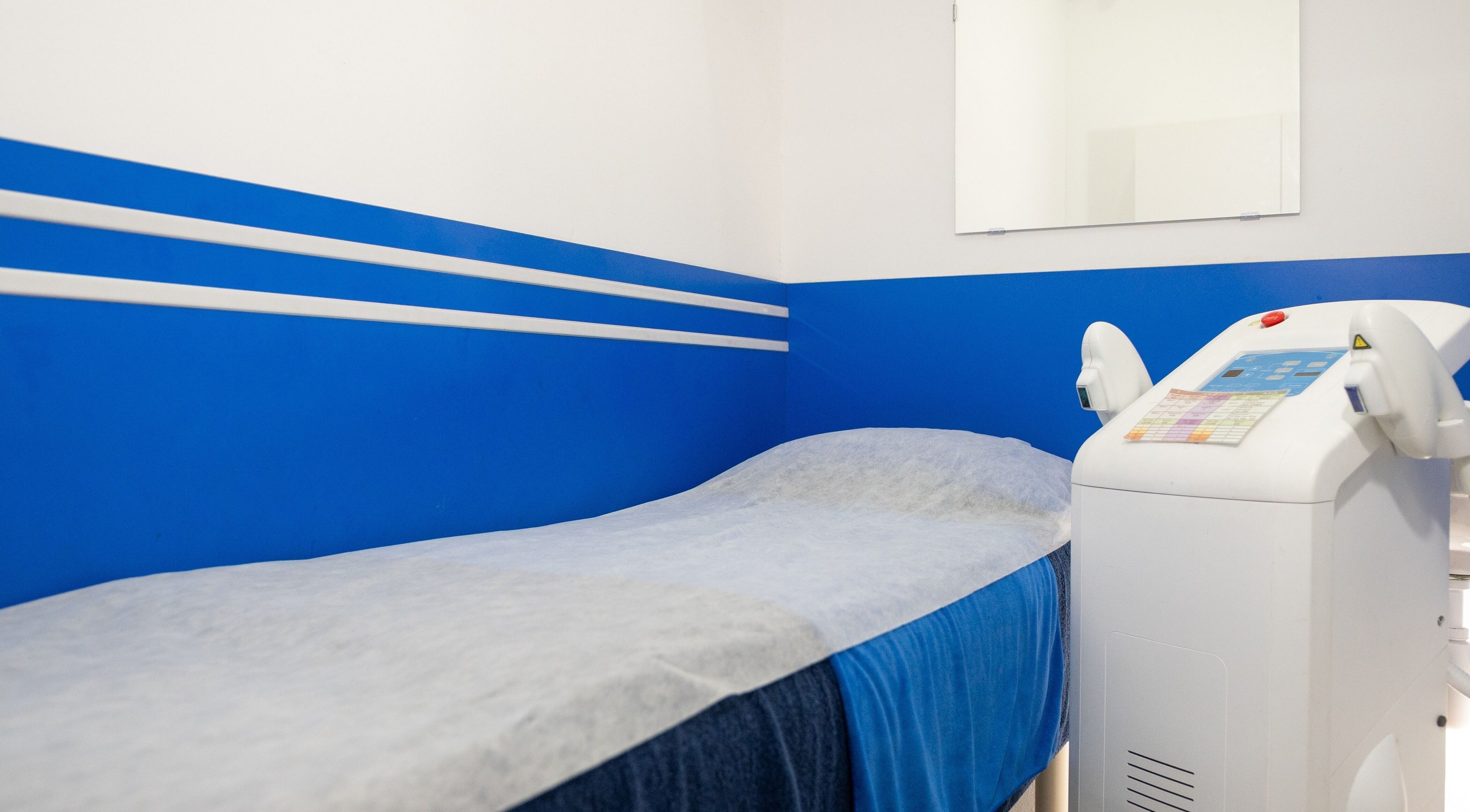 Modern treatment room at Wax Factor Tanjong Pagar, Singapore, SG with blue accents and advanced equipment.