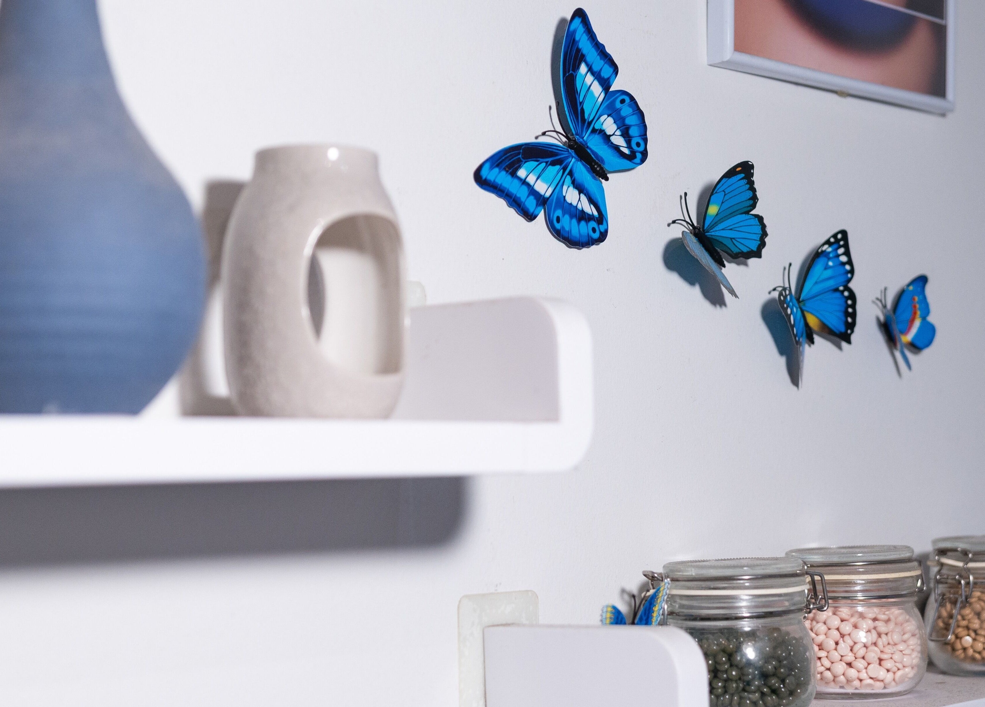 Decorative blue butterflies on wall at Wax Factor Orchard Central, Singapore, Singapore, SG.