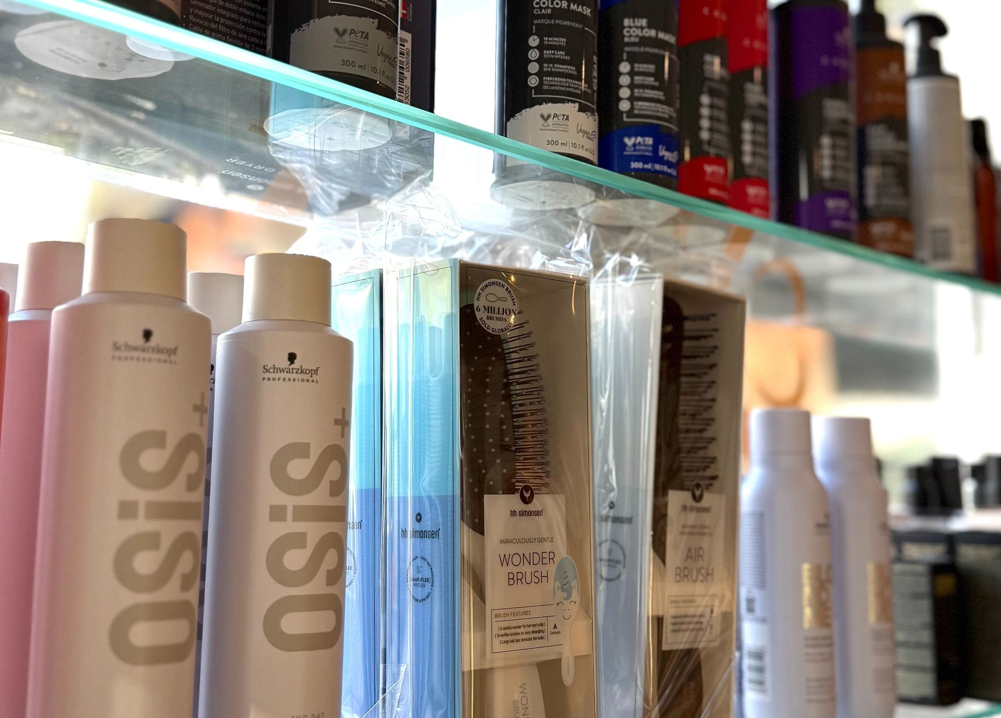 Hair products and brushes displayed on a shelf at Salong Rót in Tórshavn, Streymoyar, FO.