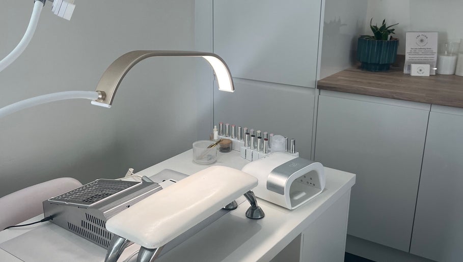 Elegant nail station at Nailsbyalicha in Portsmouth, England, GB, showcasing manicure tools and polish.