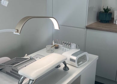 Elegant nail station at Nailsbyalicha in Portsmouth, England, GB, showcasing manicure tools and polish.